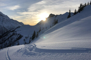 snowy mountain with ski tracks