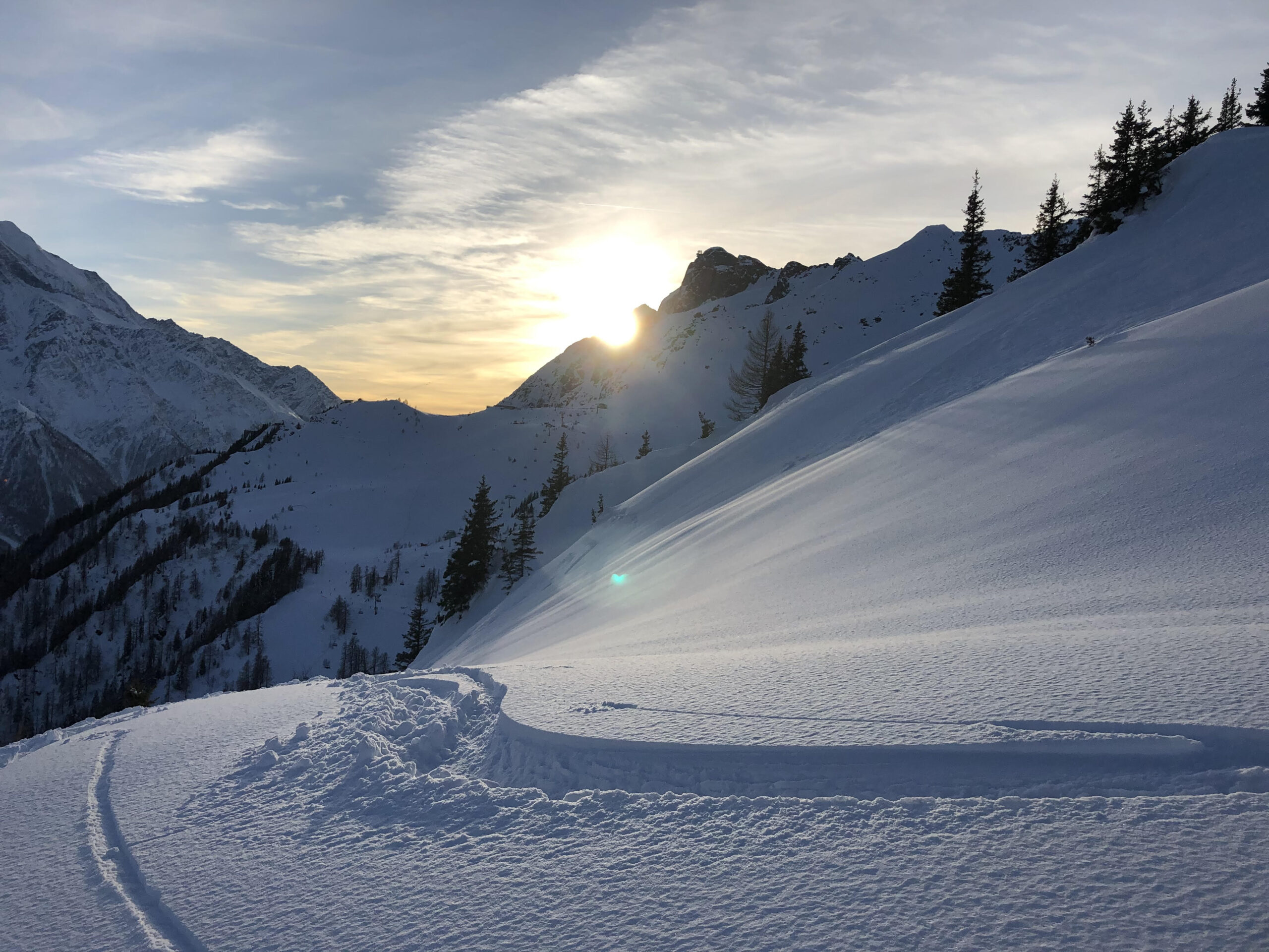 snowy mountain with ski tracks
