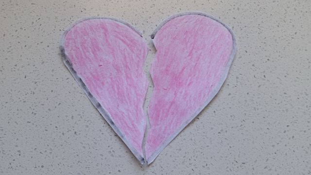 Pink paper heart split into two