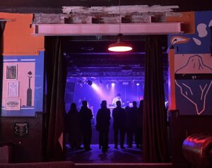 Crowd and stage at Dark Arts festival, taken from the back of the venue.