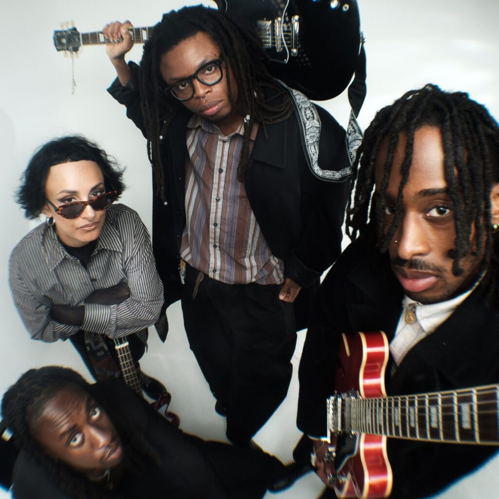 Whitelands pose for a photo with guitars