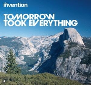 Album cover for The Invention's latest record 'Tomorrow Took Everything'. Bright picture of snowy mountains, blue sky and some green hilltop in the foreground.
