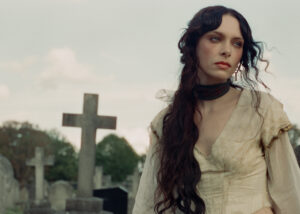 Holly Humberstone walks through a cemetery