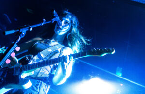 Florence Road frontwoman Lily Aron sings and plays guitar on stage at The Wardrobe